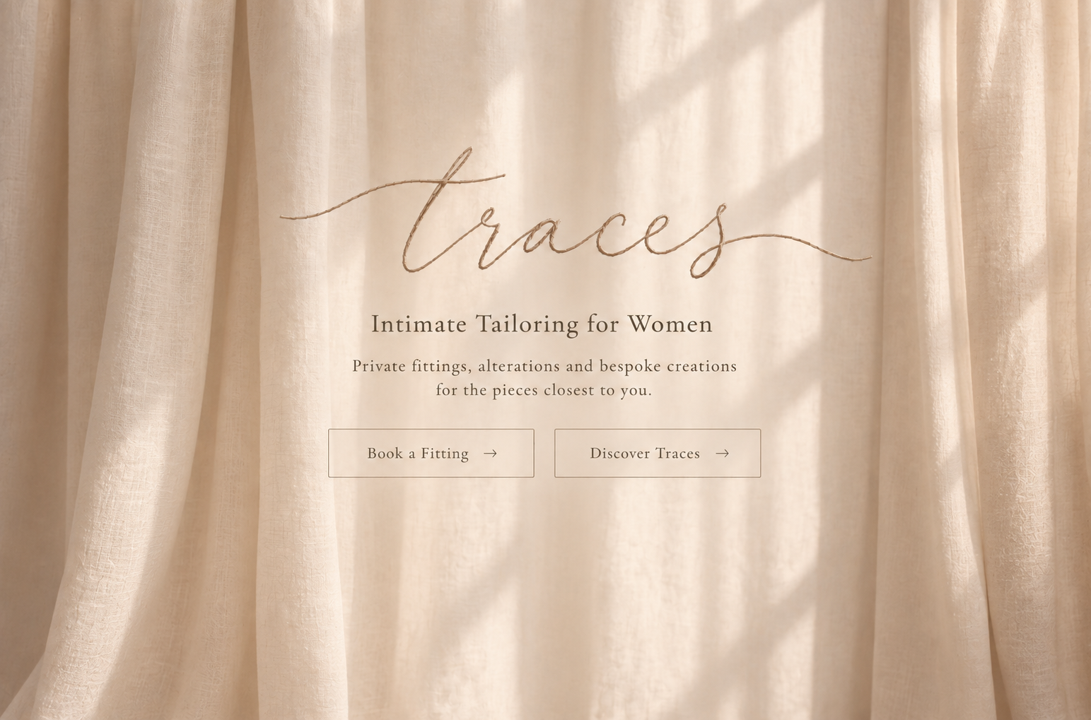 Softly lit muted nude curtains behind the Traces lettering and fitting links.